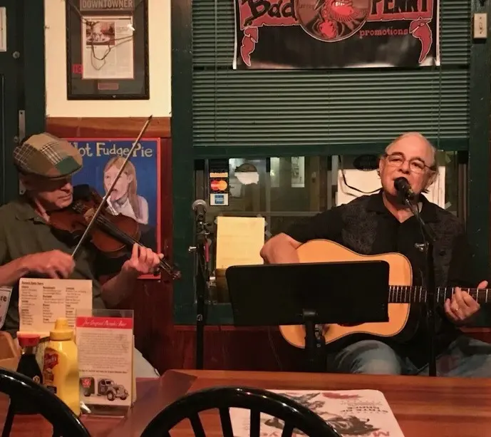 Dave Miller performing with fiddle player at a bar